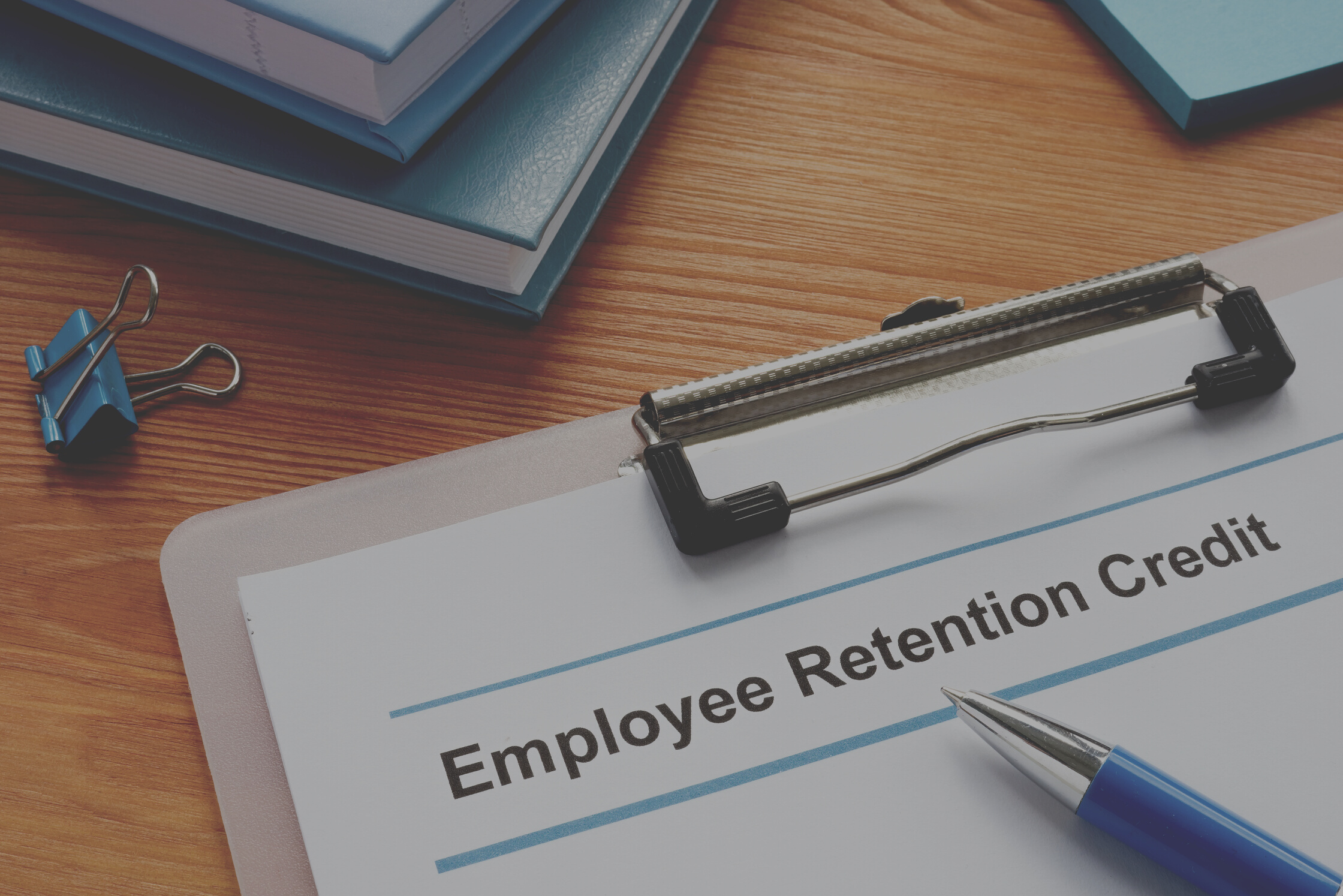 Employee retention credit application and a clipboard.